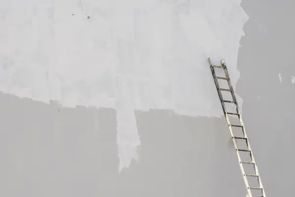 Exterior painting in Topeka: ladder against a freshly primed wall